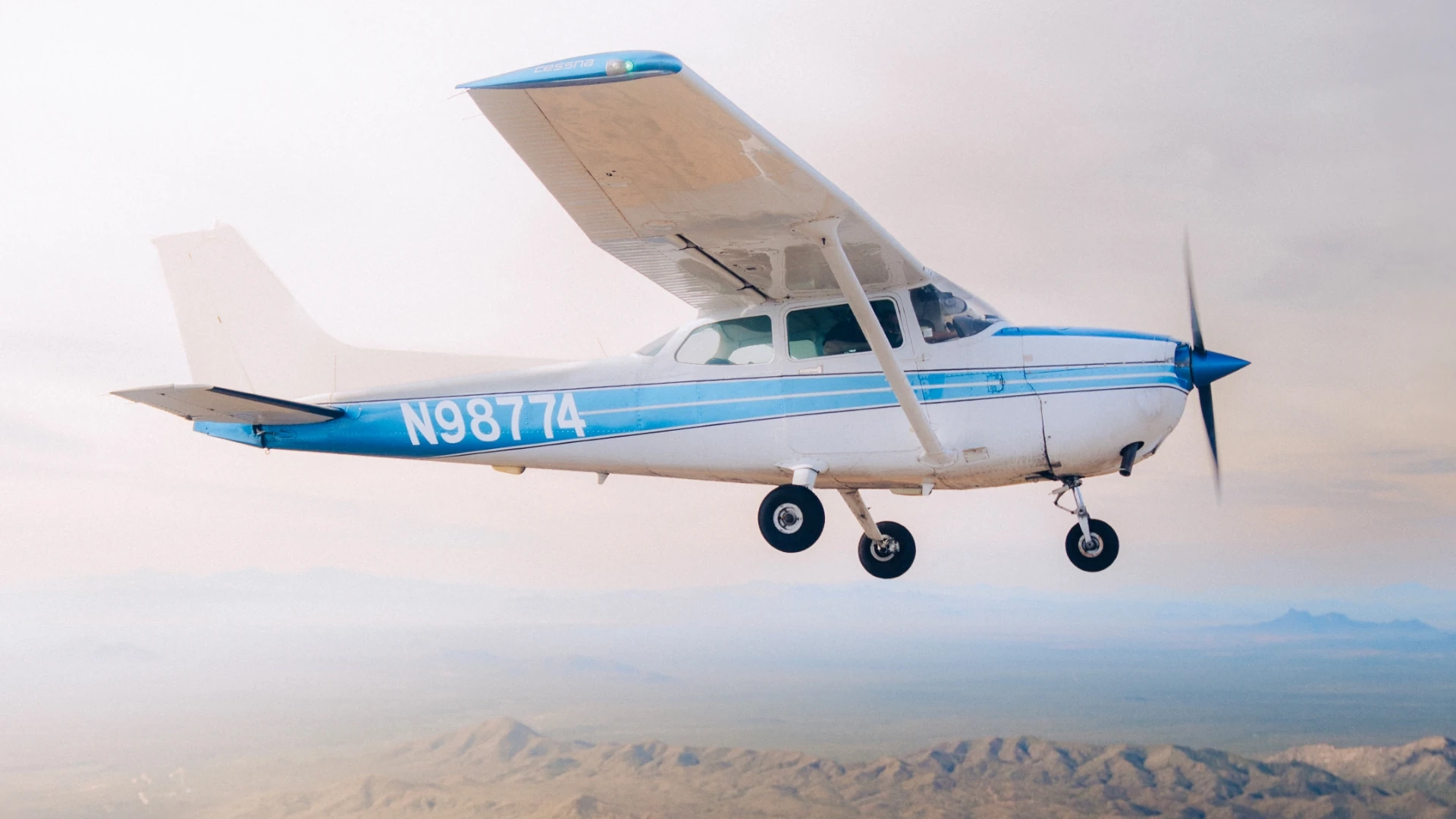 SimpliFly Flight School Cessna 172 in flight over the Arizona desert