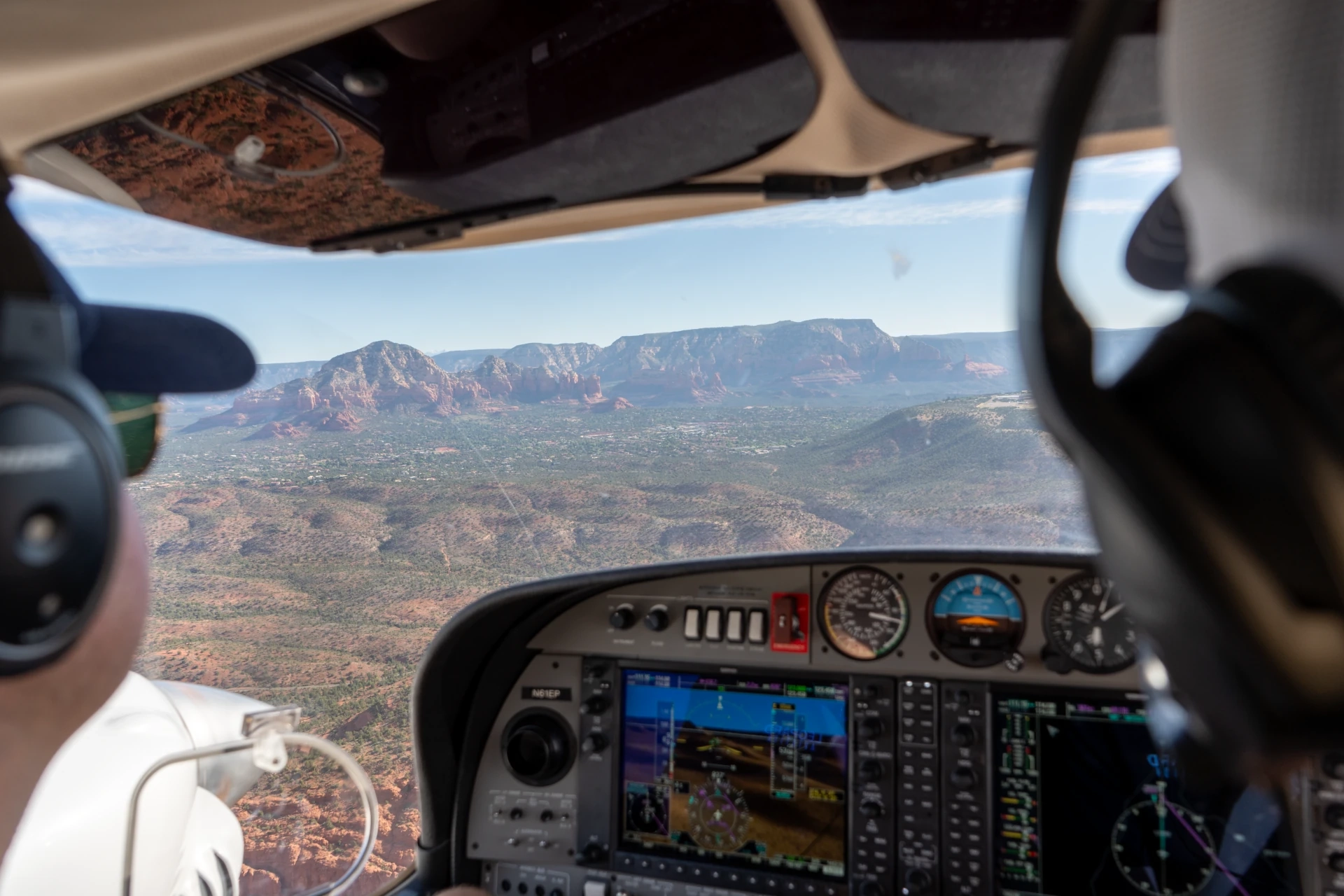 Photograph of a SimpliFly Flight School aircraft soaring over the Arizona landscape
