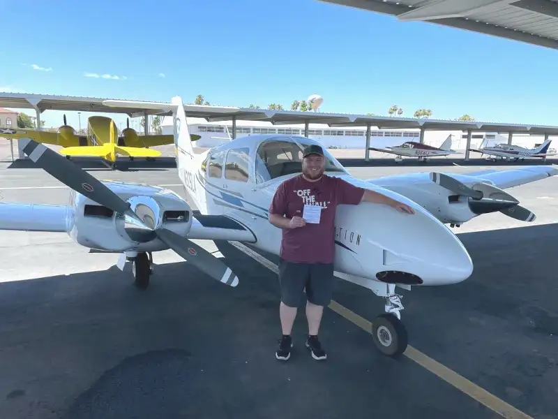 SimpliFly Flight School student by a multi-engine airplane