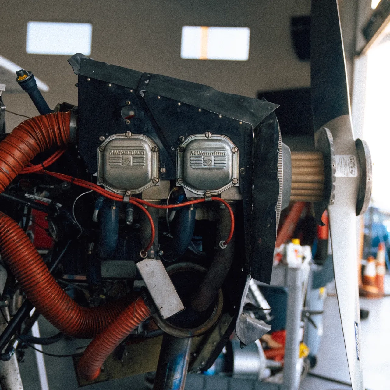 Uncowled aircraft engine inside hangar