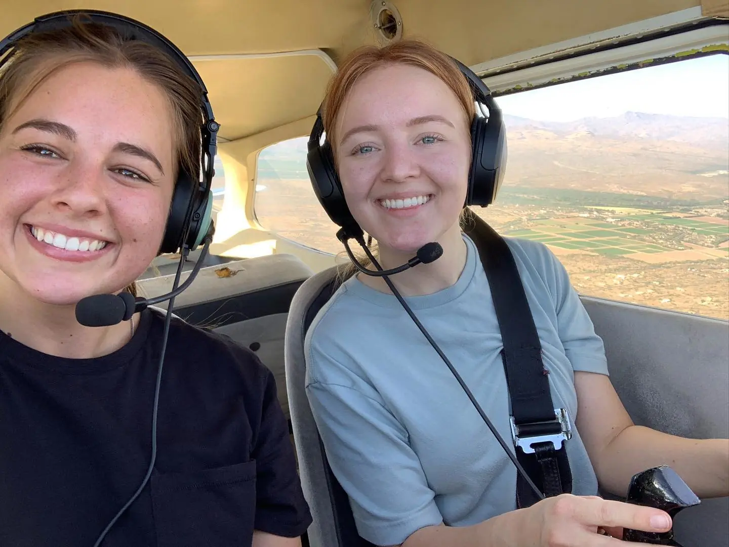 Student pilot smiling inside flying aircraft